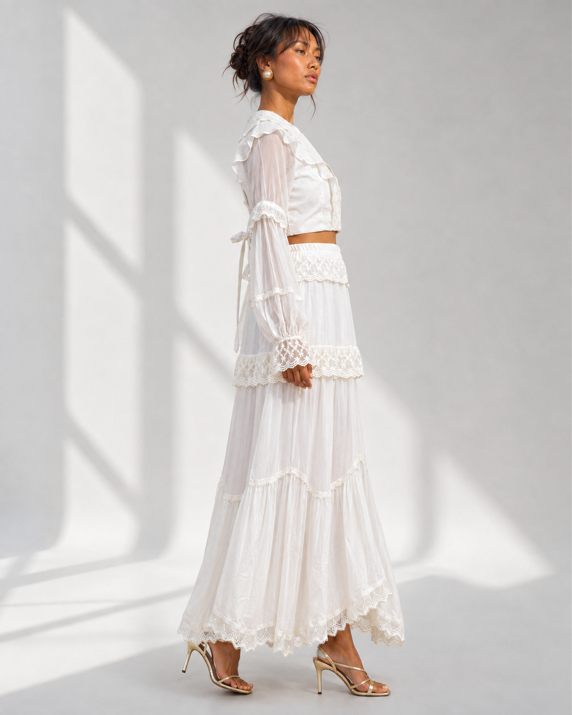 MORWENNA ivory lace tiered skirt in profile showing the full sweep of the hem.