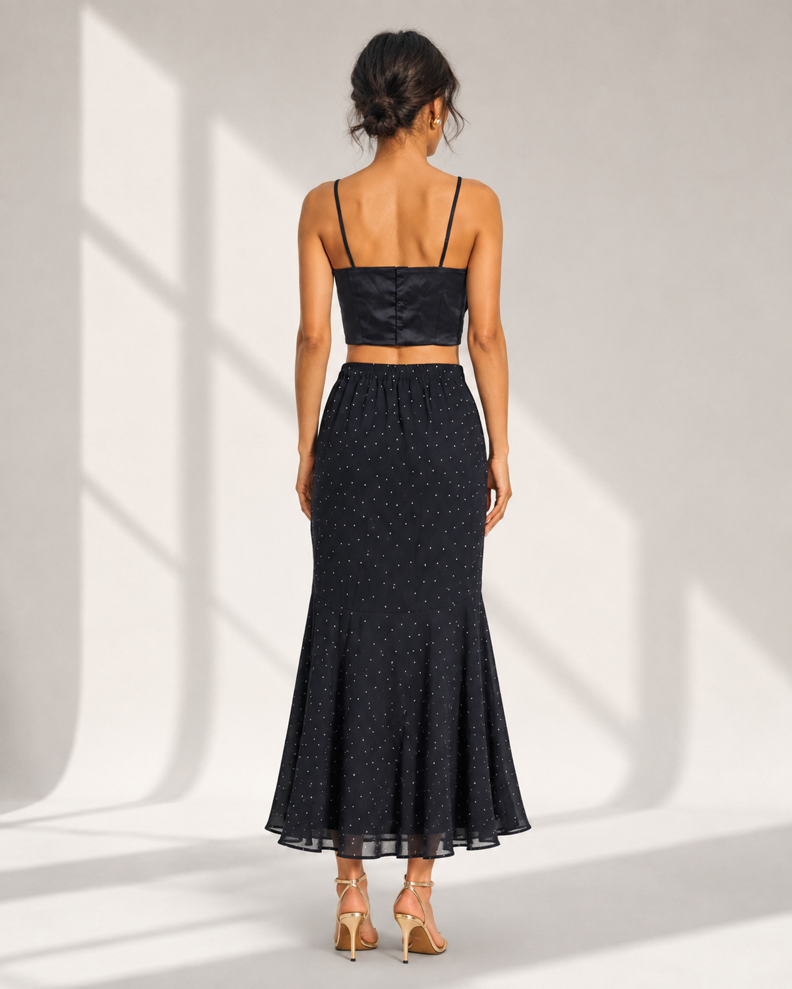 Back view of the FIAMMETTA black dot mermaid skirt showing the elasticated back waist.
