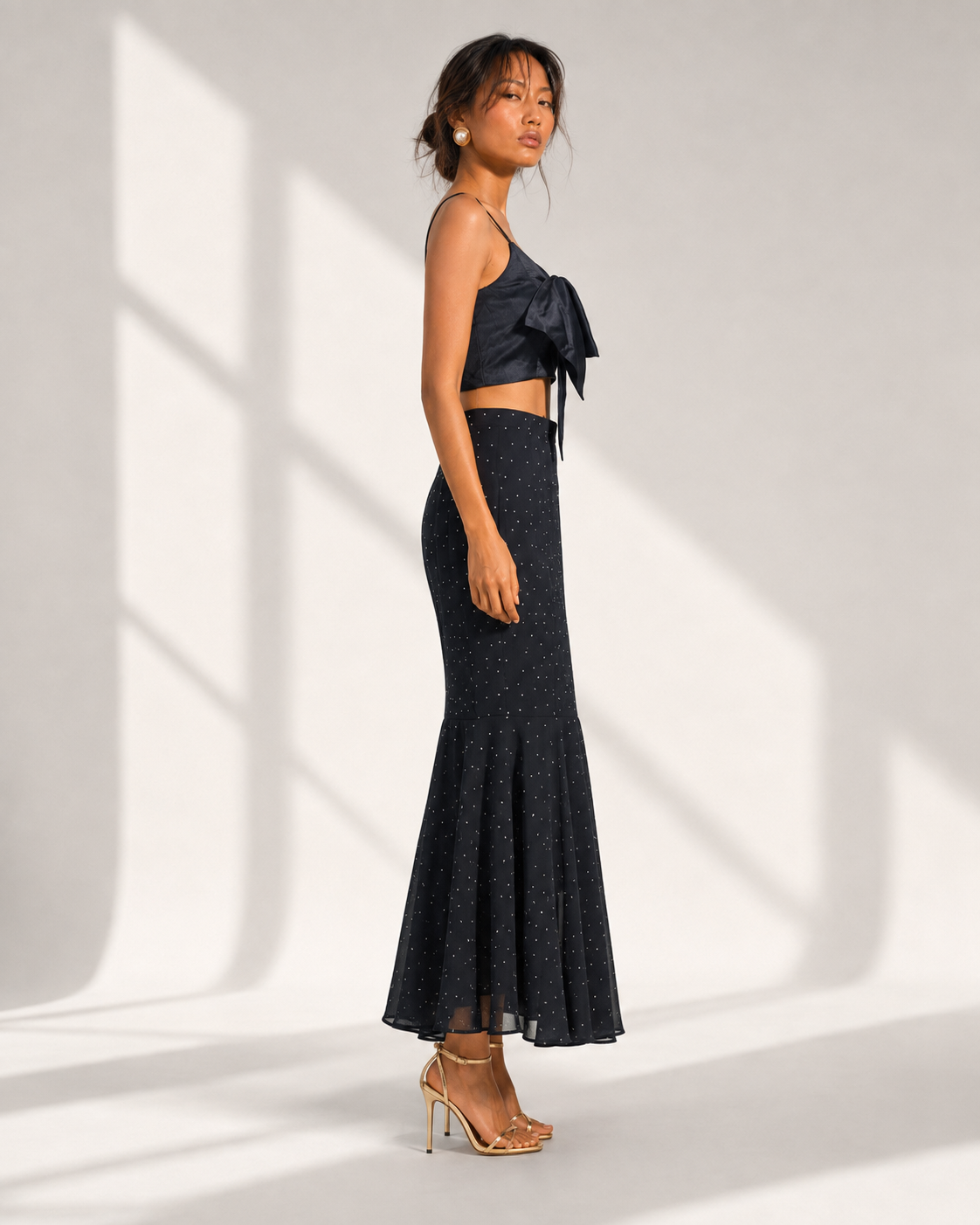 FIAMMETTA black micro dot mermaid skirt in profile showing the fishtail flounce hem.