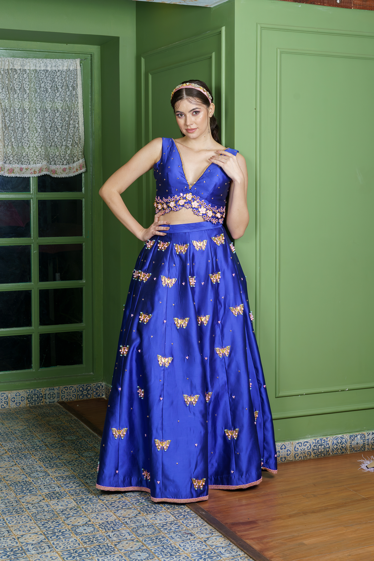 Front view of royal blue bridal lehenga with butterfly embroidery