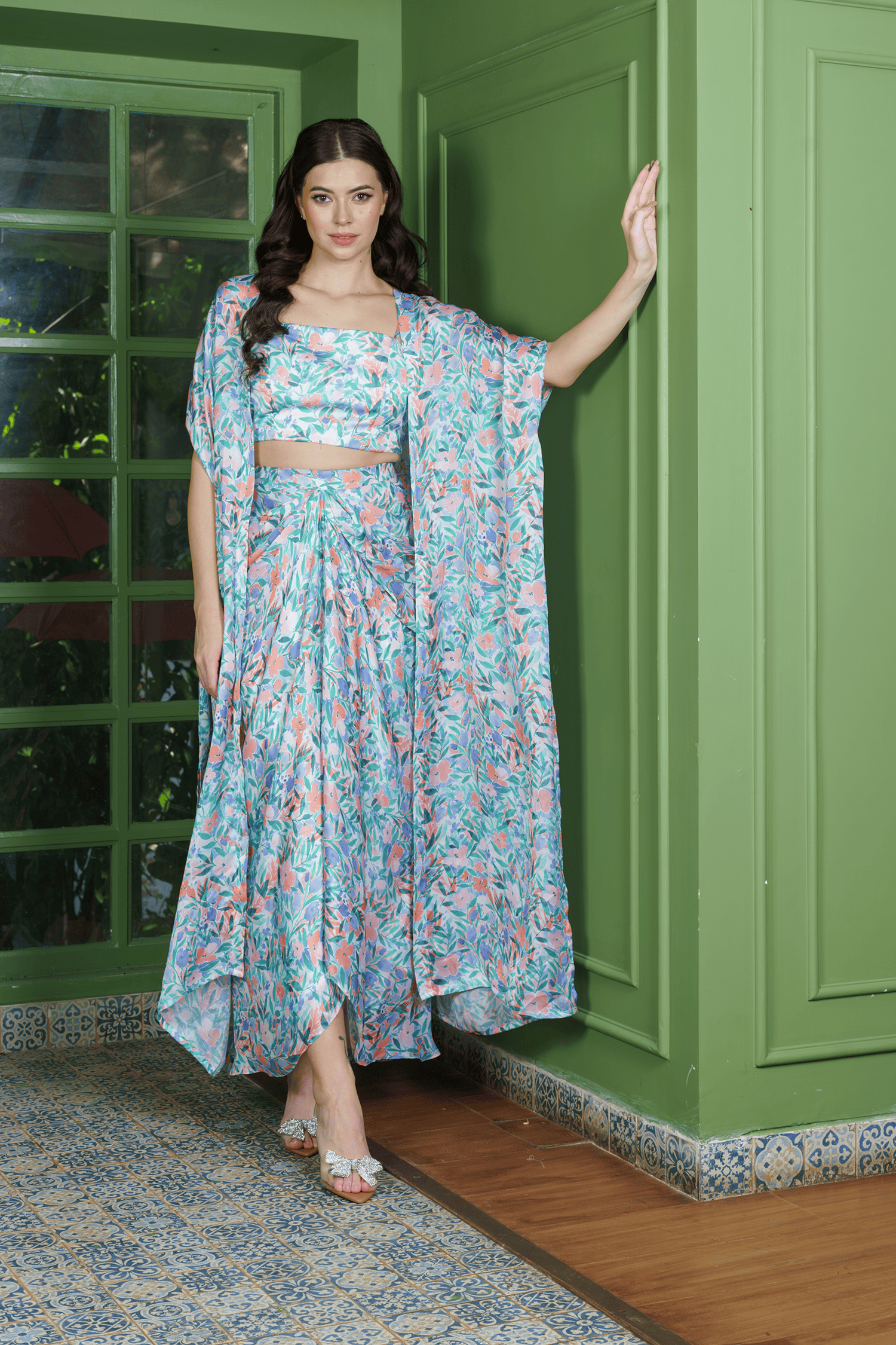 Trendy leafy print dhoti set ?stylish indo western fusion wear for weddings or festive events, featuring a crop top, draped dhoti skirt, and long jacket.