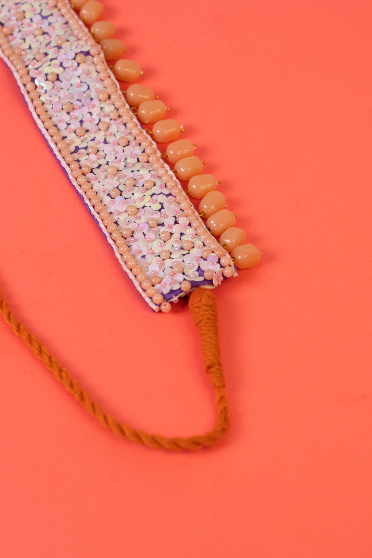 Sequins beaded choker with pearl drop .