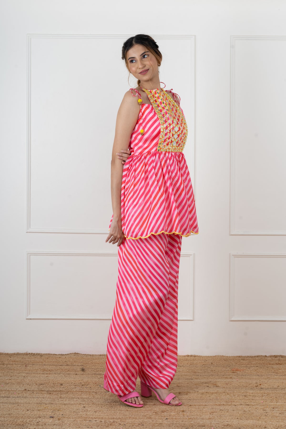 Paakhi pink leheriya satin flap kurta with machine-set mirror yoke and doori shoulder ties.