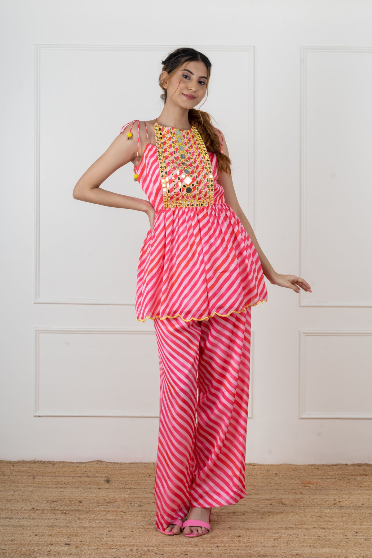 Paakhi flap kurta and flared sharara in pink and red candy leheriya satin.