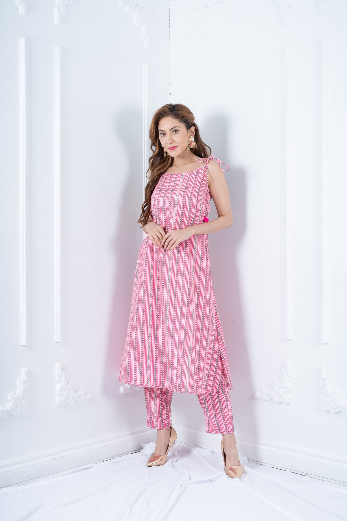 RHEA rose pink cotton kurta with tie-up shoulder straps and pom-pom tassels by Neha Sharma Label.