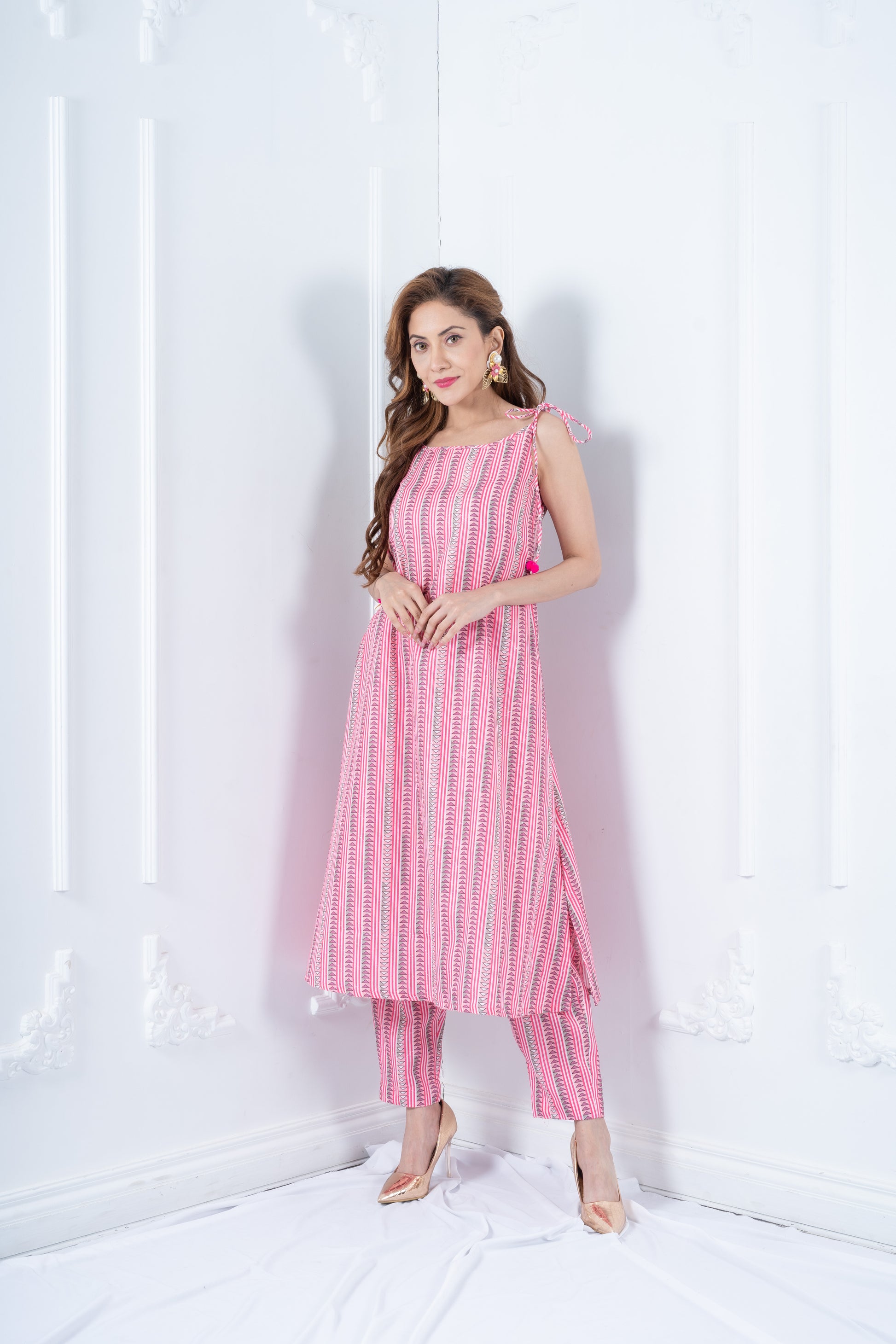 RHEA rose pink cotton kurta with tie-up shoulder straps and pom-pom tassels by Neha Sharma Label.