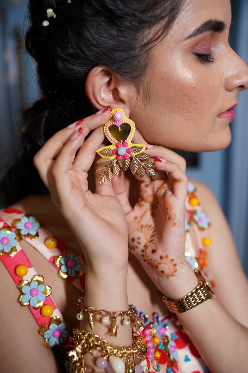 Yellow mirror beaded earrings .