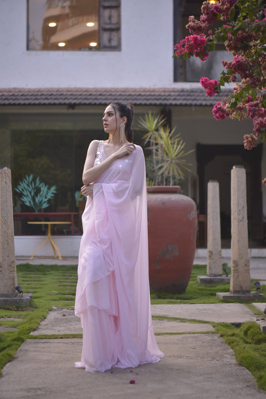 Pastel pink ruffle saree with mirror work blouse